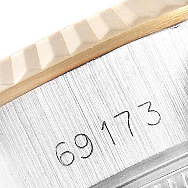 This close-up shows the case side and fluted bezel of a Rolex Datejust 69173 Women
s Steel and Gold (two tone) Champagne Dial 69173 Women
s Steel and Gold (two tone) Champagne Dial, revealing the model number 69173.