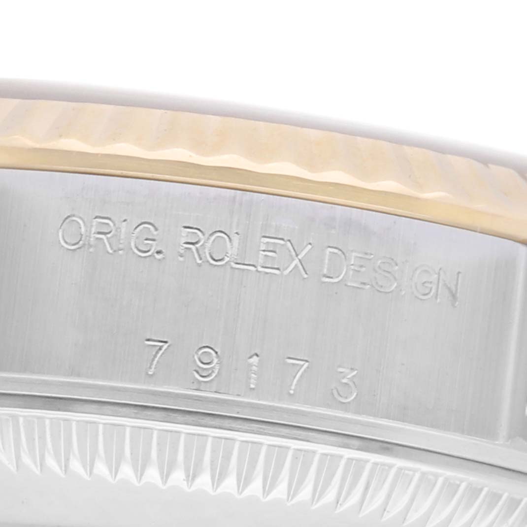 The image shows a close-up of the side of a Rolex Datejust, model 79173, highlighting the engraving "ORIG. ROLEX DESIGN" and the model number.