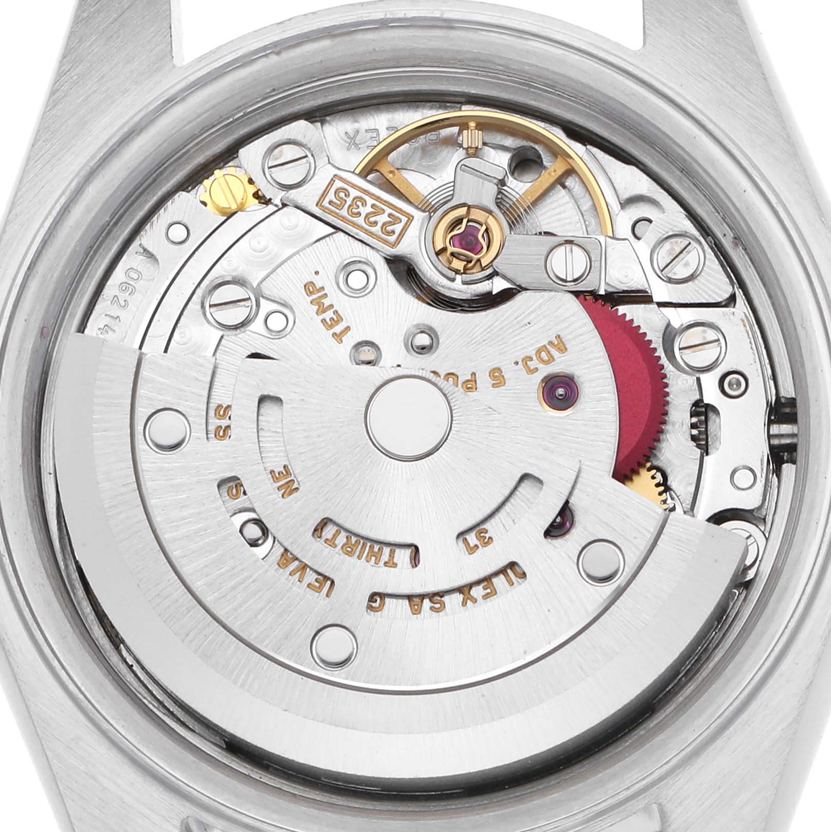 The image shows the movement mechanism of a Rolex Datejust model 79173, highlighting the rotor, gears, and intricate internal components from a back angle.