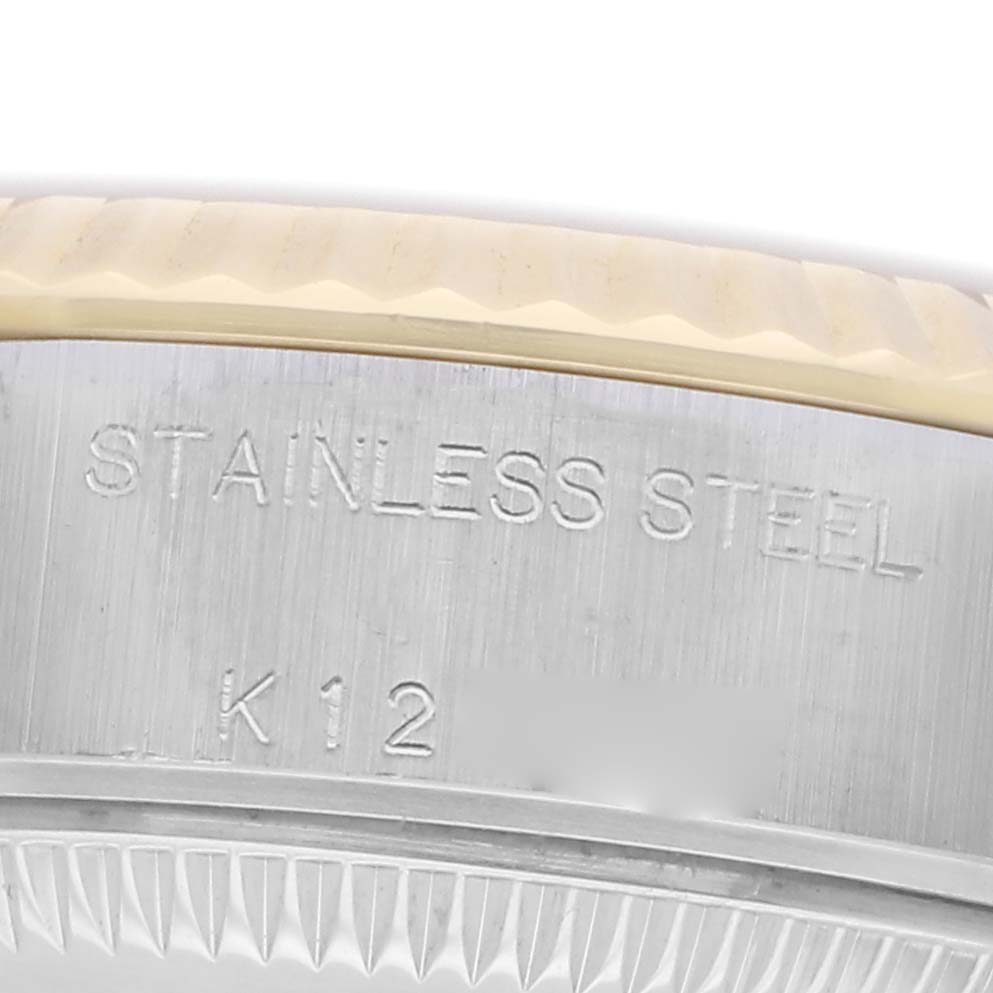 The image shows a close-up of the side of a Rolex Datejust model 79173, focusing on the stainless steel case with engraved text.