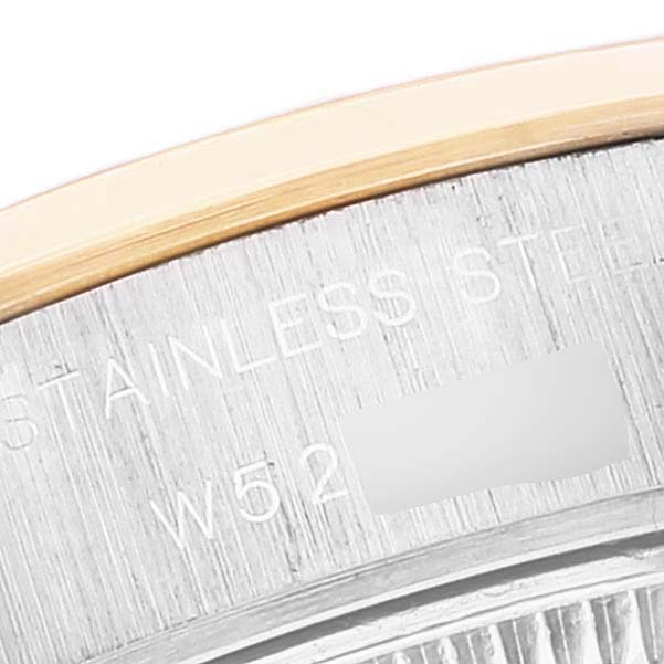 The image shows a close-up view of the case back edge and part of the bezel of a Rolex Datejust 69163 Women
s Steel and Gold (two tone) Mother of Pearl Dial 69163 Women
s Steel and Gold (two tone) Mother of Pearl Dial watch, highlighting the engraved "Stainless Steel" text.