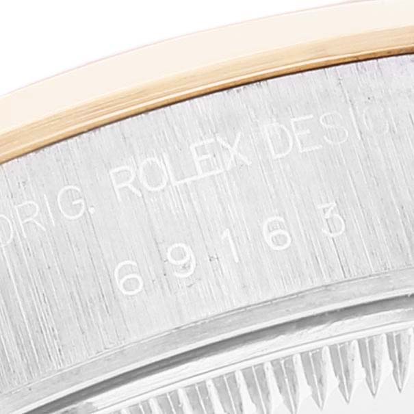 This image shows a close-up of the engraved side of the bezel on a Rolex Datejust 69163 Women
s Steel and Gold (two tone) Mother of Pearl Dial 69163 Women
s Steel and Gold (two tone) Mother of Pearl Dial, model number 69163.