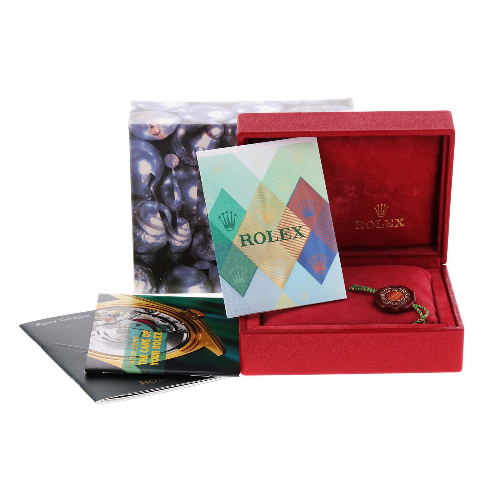 The image shows a Rolex Datejust 79163 Women
s Steel and Gold (two tone) Mother of Pearl Dial 79163 Women
s Steel and Gold (two tone) Mother of Pearl Dial watch box, along with booklets and the tag, arranged at a slight angle.