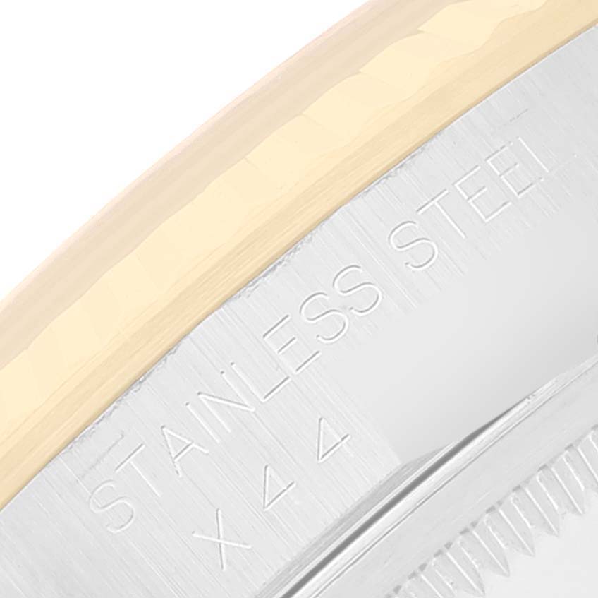 This image shows a close-up of the side of the bezel on a Rolex Datejust 16233 Men's Steel and Gold (two tone) Champagne Dial 16233 Men's Steel and Gold (two tone) Champagne Dial watch, highlighting the "STAINLESS STEEL X44" engraving.
