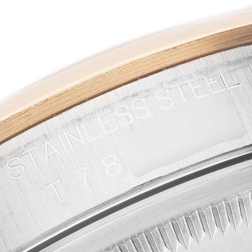 The image shows a close-up of the stainless steel and gold bezel of a Rolex Datejust 16203 Men's Stainless Steel White Dial watch, focusing on engraved text.