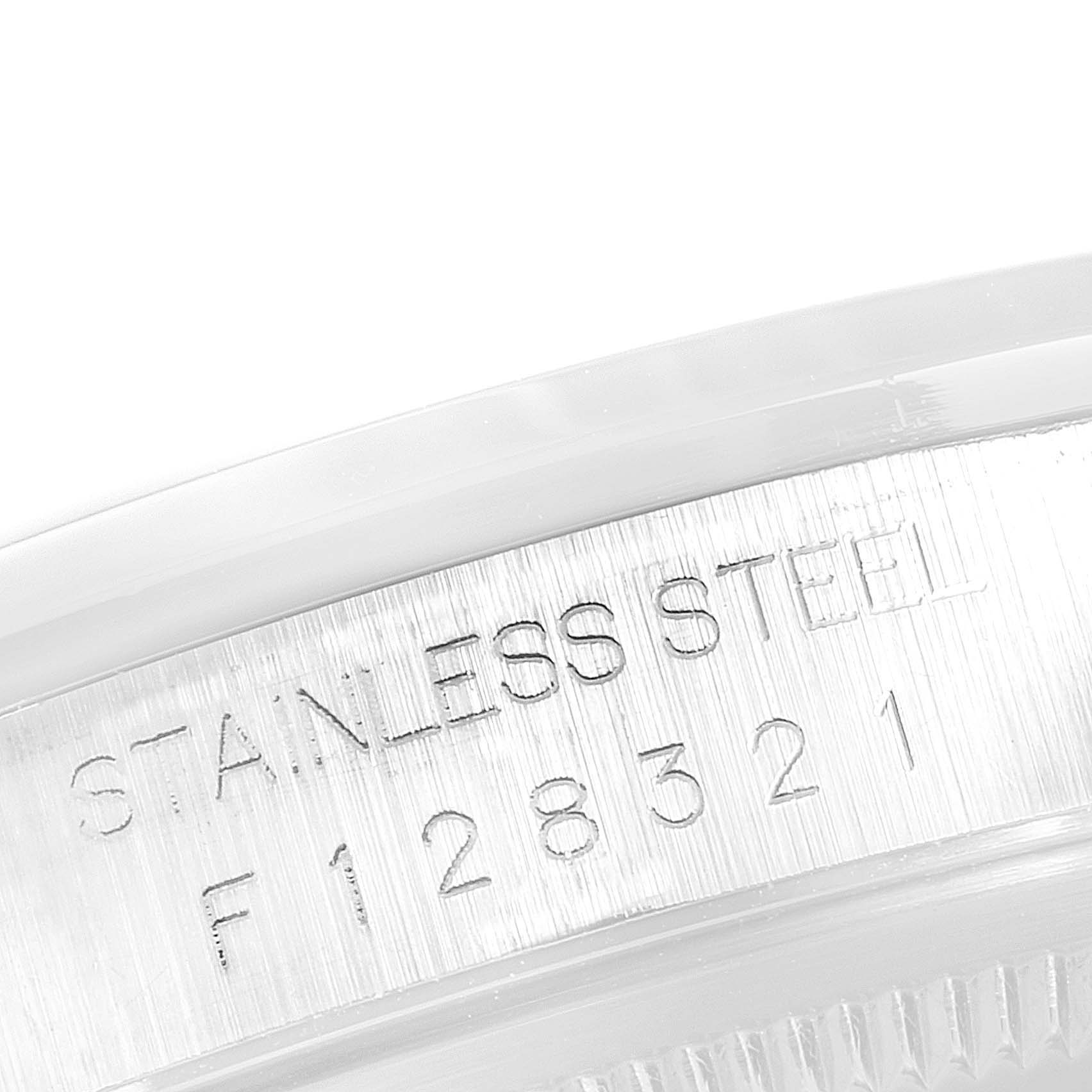 This close-up photo shows the serial number and "Stainless Steel" engraving on the case of a Rolex Datejust 16200 Men's Stainless Steel White Dial 16200 Men's Stainless Steel White Dial watch.
