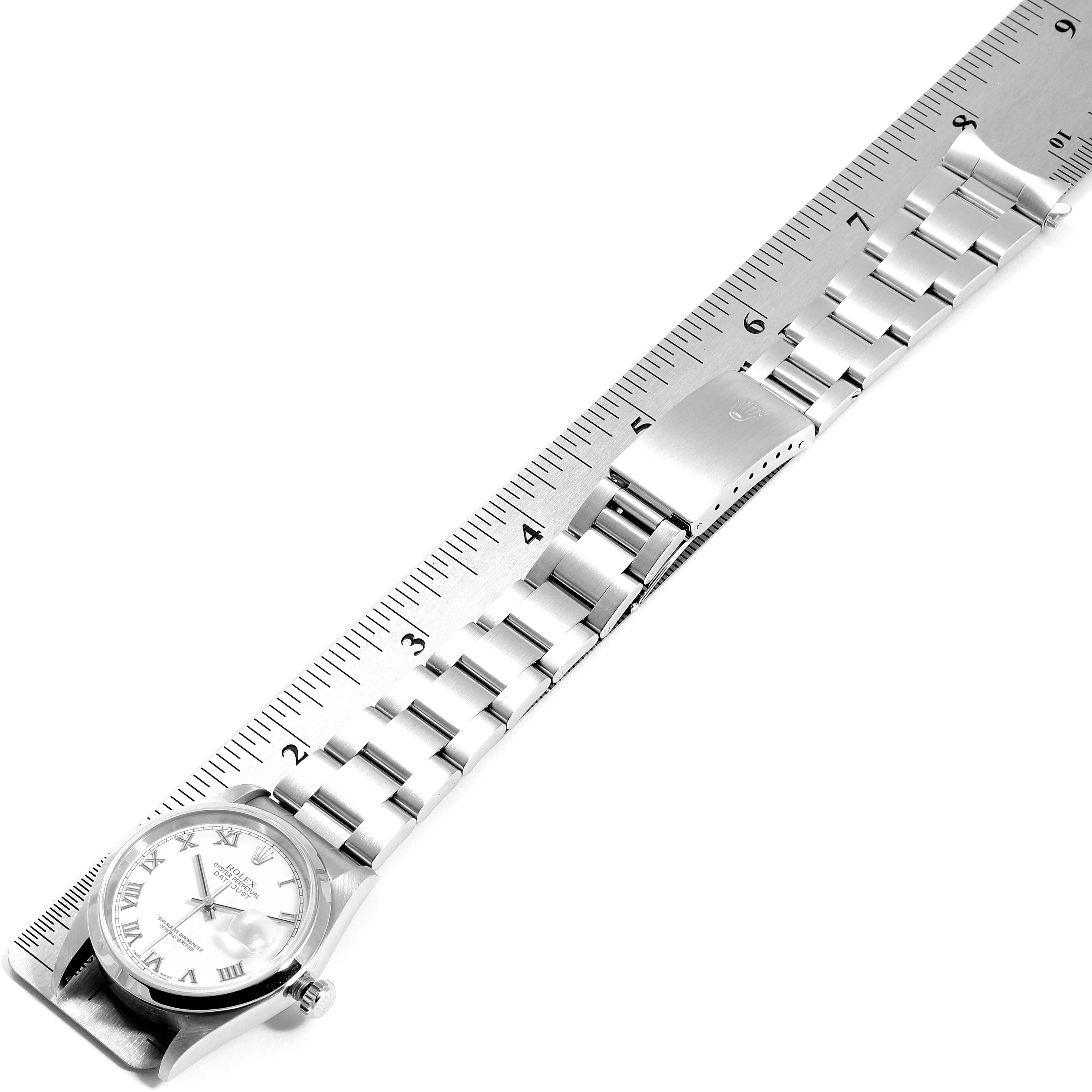 The image shows a Rolex Datejust 16200 Men's Stainless Steel White Dial 16200 Men's Stainless Steel White Dial watch at a slight angle, highlighting its bracelet and clasp against a ruler for size reference.