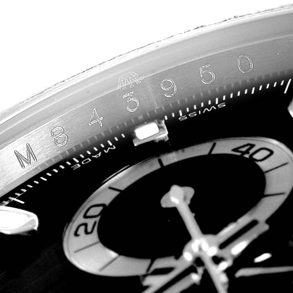 The image shows a close-up of the dial and bezel marking details of a Rolex Daytona 116520 Men's Stainless Steel Black Dial 116520 Men's Stainless Steel Black Dial watch.