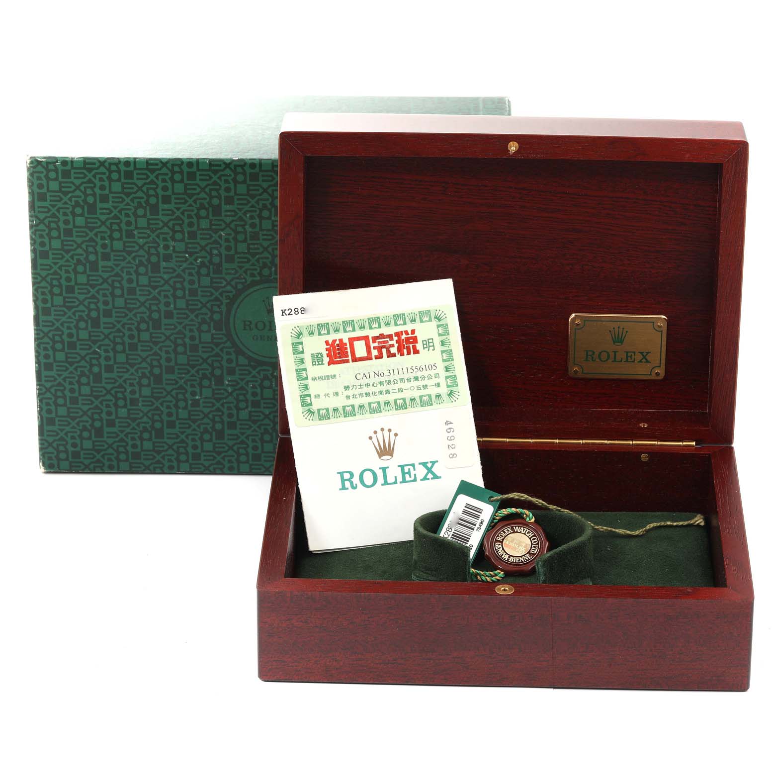 The image shows a wooden box for a Rolex Daytona 116520 Men's Stainless Steel Black Dial 116520 Men's Stainless Steel Black Dial, containing documentation and a green tag.