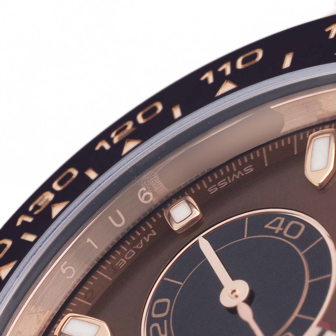 The image shows a close-up of the bezel and dial of a Rolex Daytona 116515LN Men's Rose Gold Brown Dial, highlighting the tachymetric scale and part of the sub-dial.