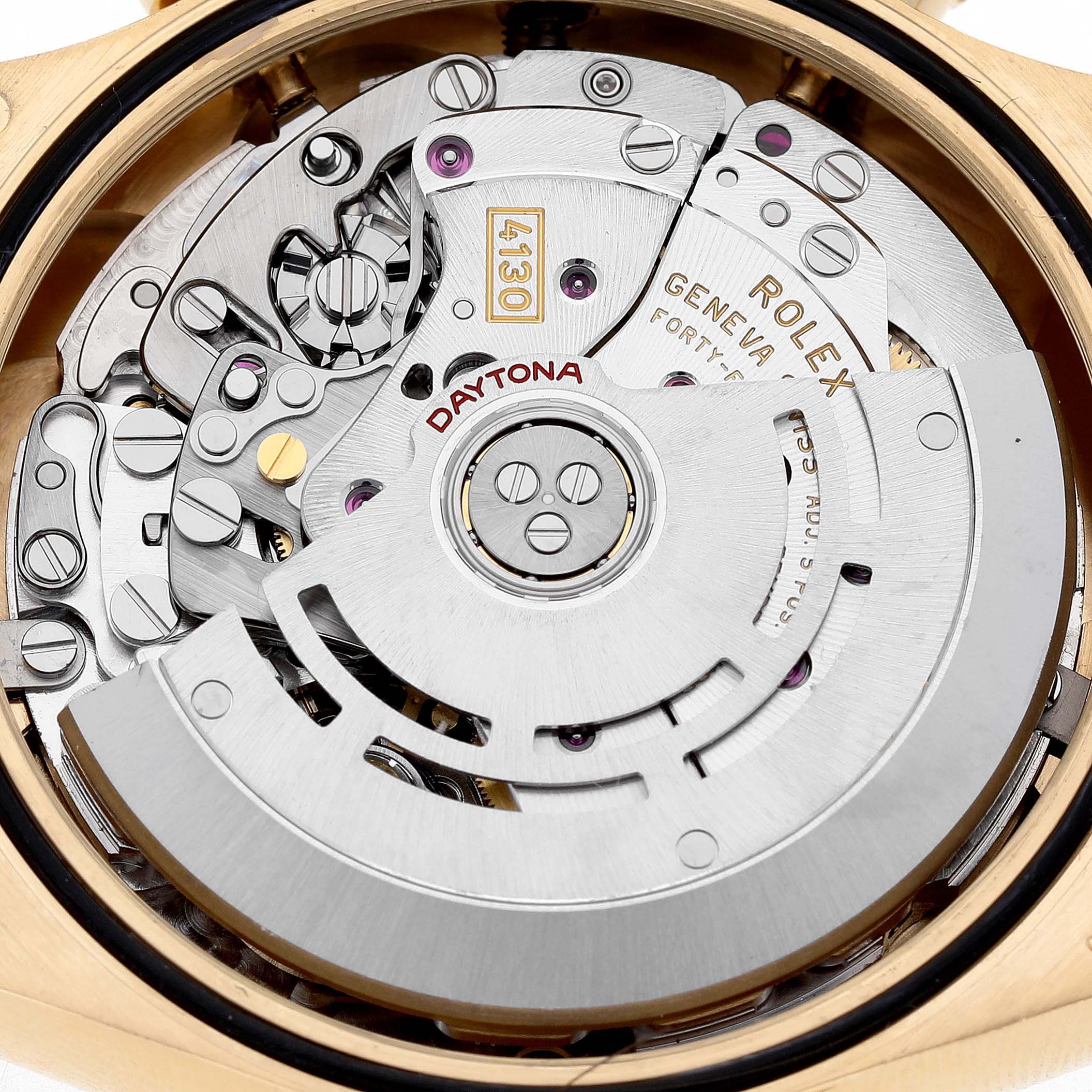 The image shows the intricate movement of a Rolex Daytona 116508 Men's Yellow Gold Black Dial watch, focusing on its mechanism and inner components.