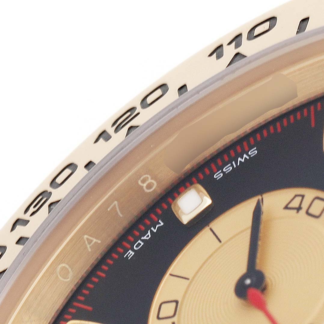 The image shows a close-up of the bezel and dial edge of a Rolex Daytona 116508 Men's Yellow Gold Black Dial, highlighting the tachymetric scale and part of the sub-dial.