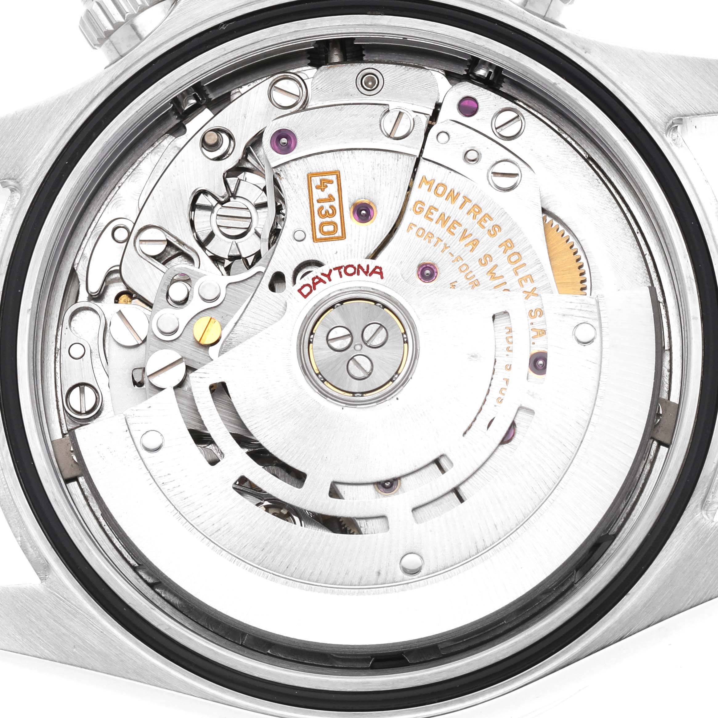The image shows the movement and rotor of a Rolex Daytona model 116520 from a back angle, highlighting the intricate inner mechanics.