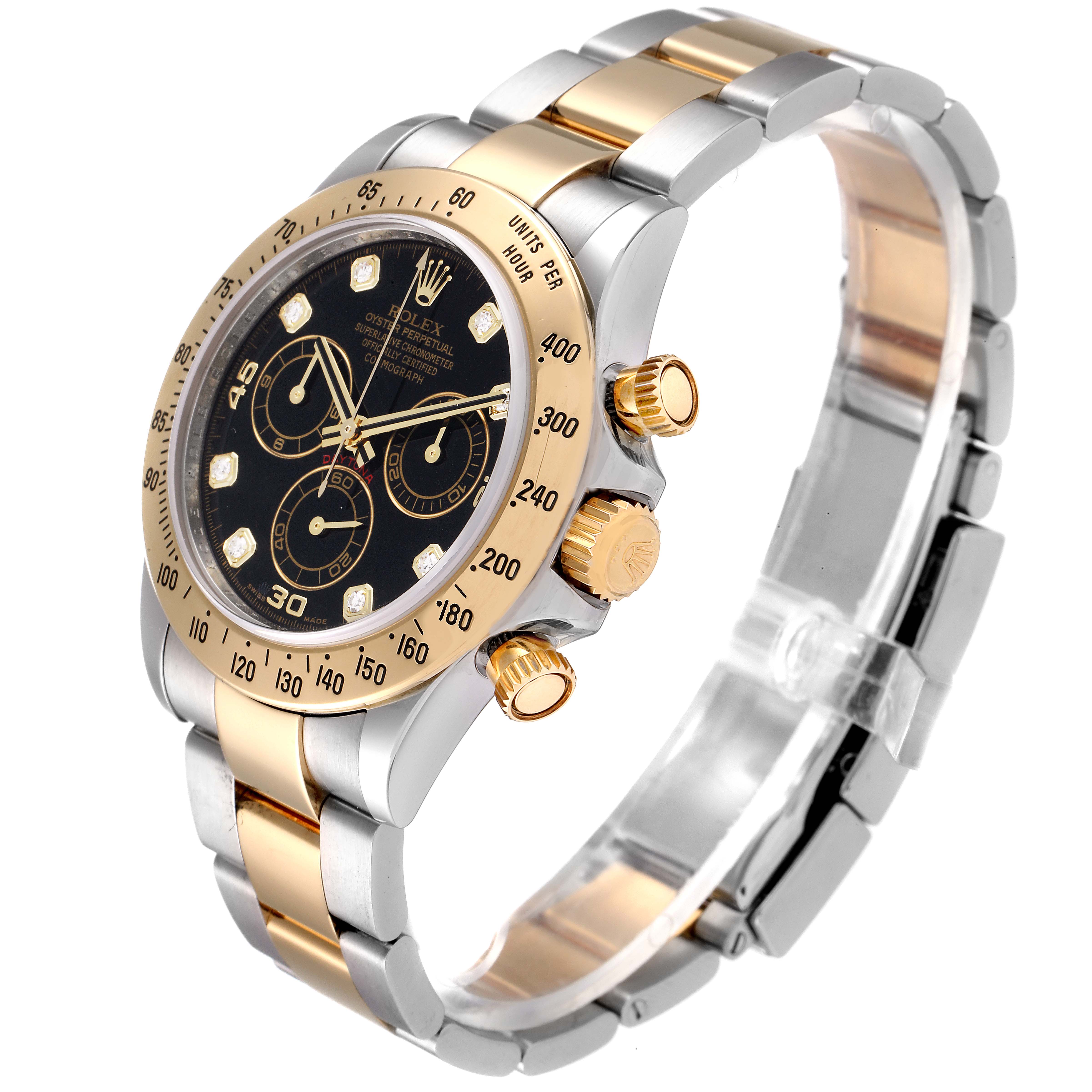 The Rolex Daytona 116523 Men's Steel and Gold (two tone) Black Dial 116523 Men's Steel and Gold (two tone) Black Dial watch shown is angled to display the face, bezel, and bracelet clearly, with a focus on the crown and pushers.