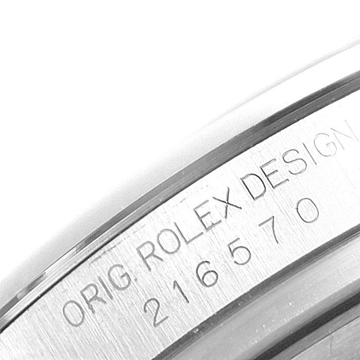 The image shows a close-up of the inner bezel of a Rolex Explorer 216570 Men
s Stainless Steel Black Dial 216570 Men
s Stainless Steel Black Dial watch, highlighting the engraved serial and model numbers.
