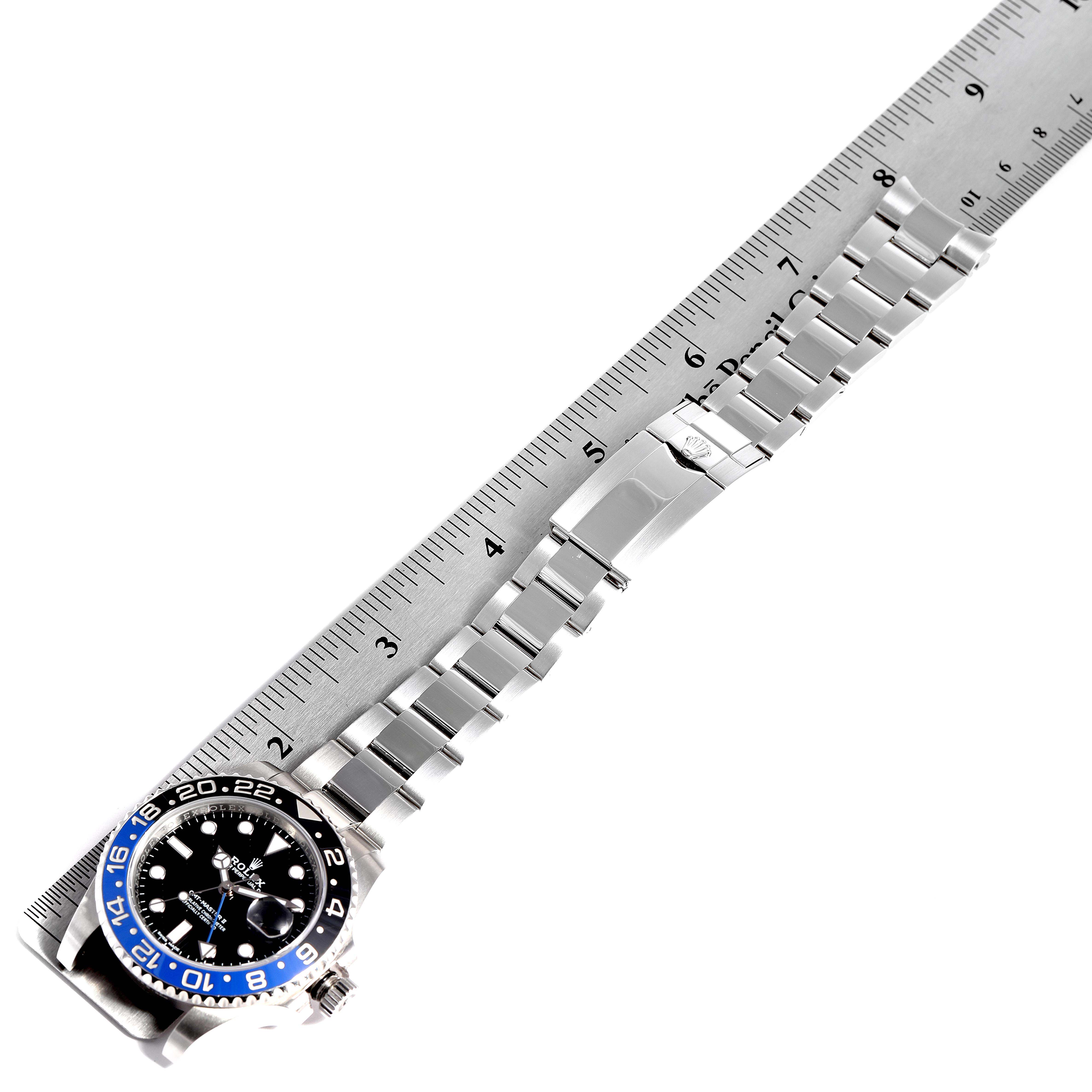 The image shows a Rolex GMT-Master 116710 Men
s Stainless Steel Black Dial 116710 Men
s Stainless Steel Black Dial watch, focusing on its face and full bracelet, placed along a ruler for measurement.