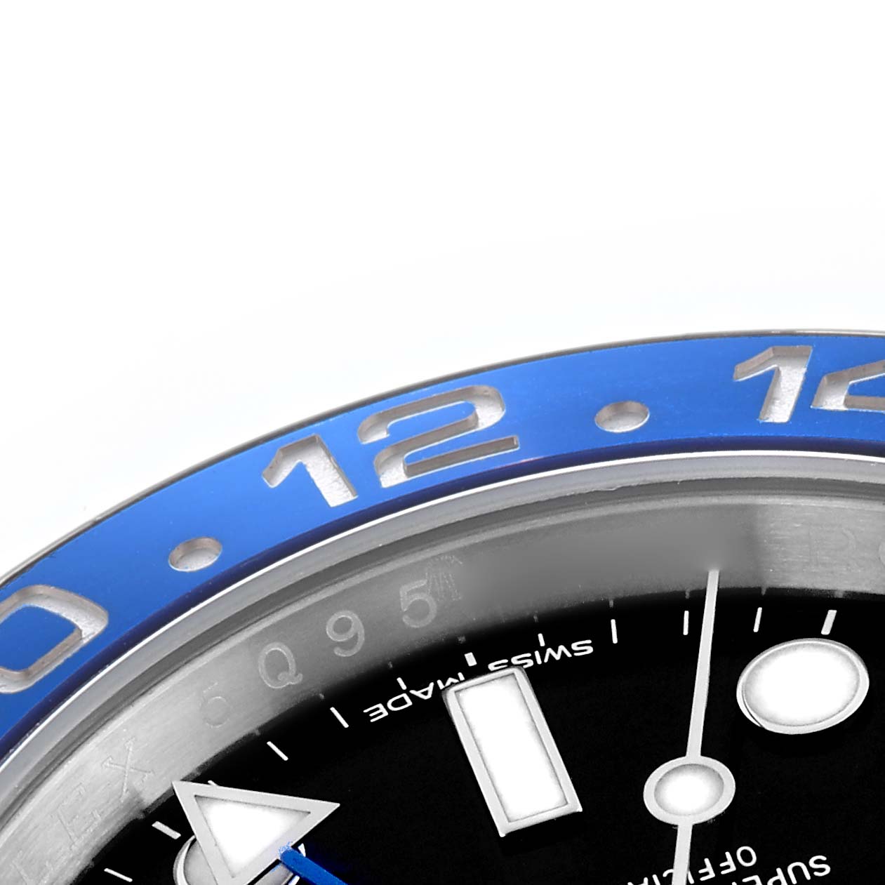 The image shows a close-up of the Rolex GMT-Master model 116710's bezel, partial dial, and hands at an angle focusing on the number "12" on the blue bezel.