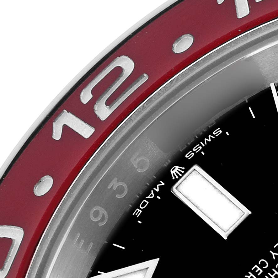 The image shows a close-up of the bezel and dial of a Rolex GMT-Master model 126710BLRO, highlighting the red section of the bezel with the number "12" and part of the dial.