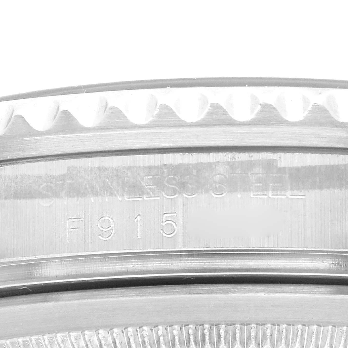 This close-up image shows the engraved bezel and serial number of a Rolex GMT-Master 16710 Men's Stainless Steel Black Dial 16710 Men's Stainless Steel Black Dial watch.