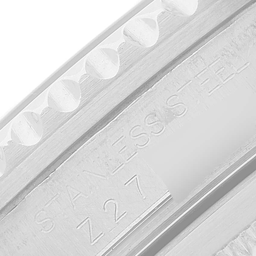 This close-up image shows the inner engraving of the GMT-Master model by Rolex, highlighting the stainless steel and part of the serial number.
