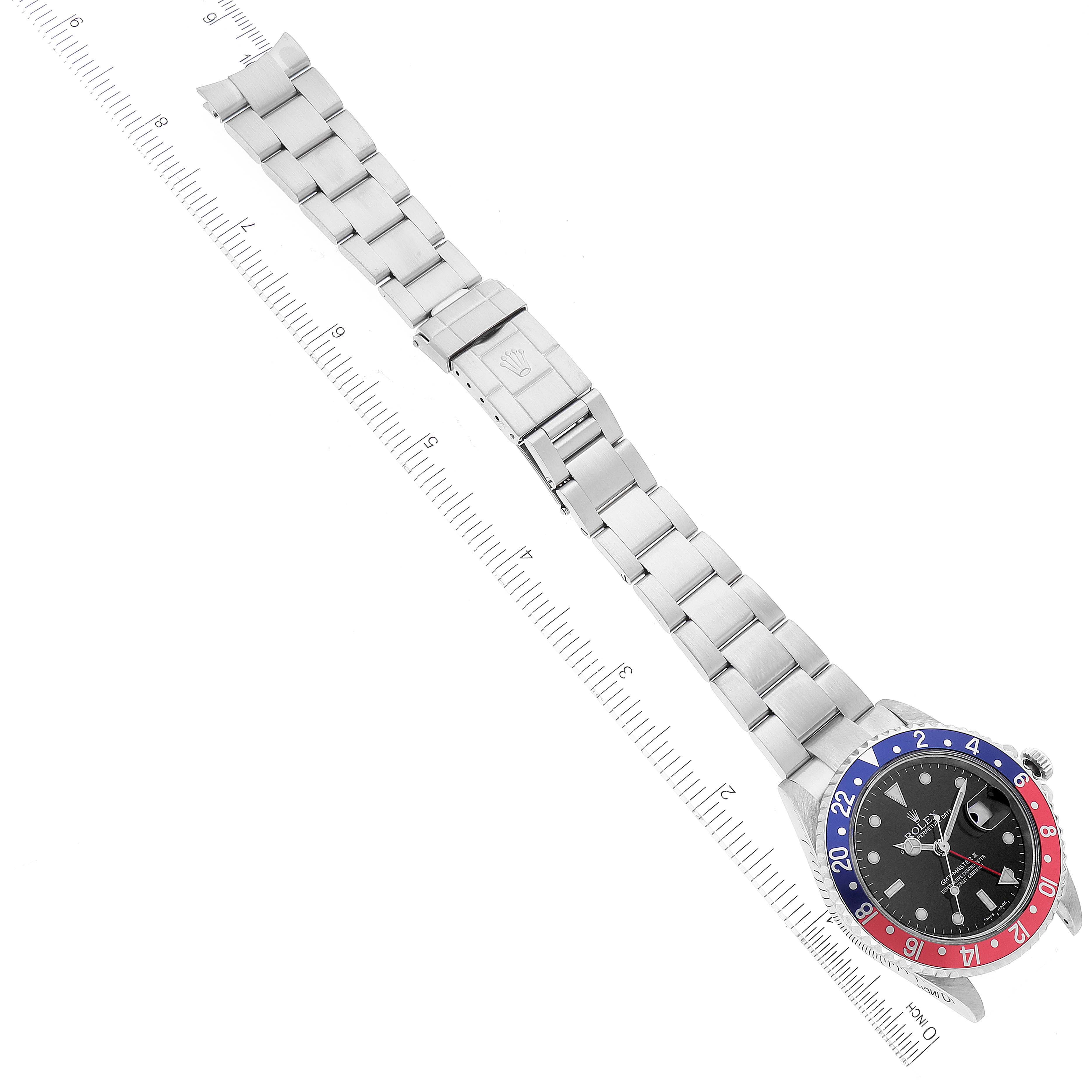 The image shows a top-down view of a Rolex GMT-Master 16710 Men
s Stainless Steel Black Dial 16710 Men
s Stainless Steel Black Dial watch, displaying the bracelet, clasp, and dial with a "Pepsi" bezel.