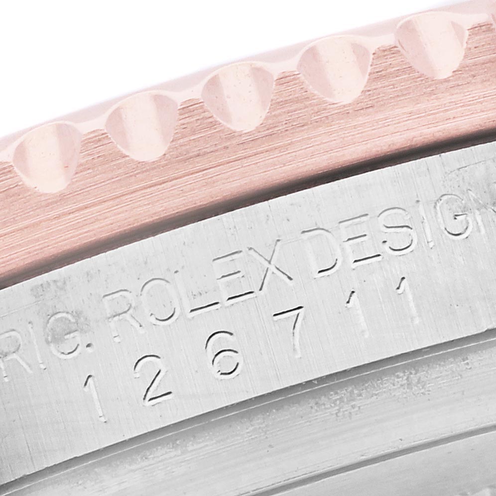The image shows a close-up of the bezel and case side of the Rolex GMT-Master, model 126711, highlighting the engraved model number.