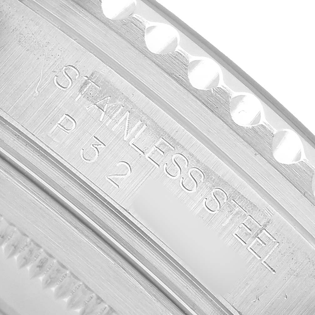 The image shows a close-up of the bezel teeth and inner engraving of the Rolex GMT-Master 16710 Men's Stainless Steel Black Dial, focusing on the "STAINLESS STEEL" text.
