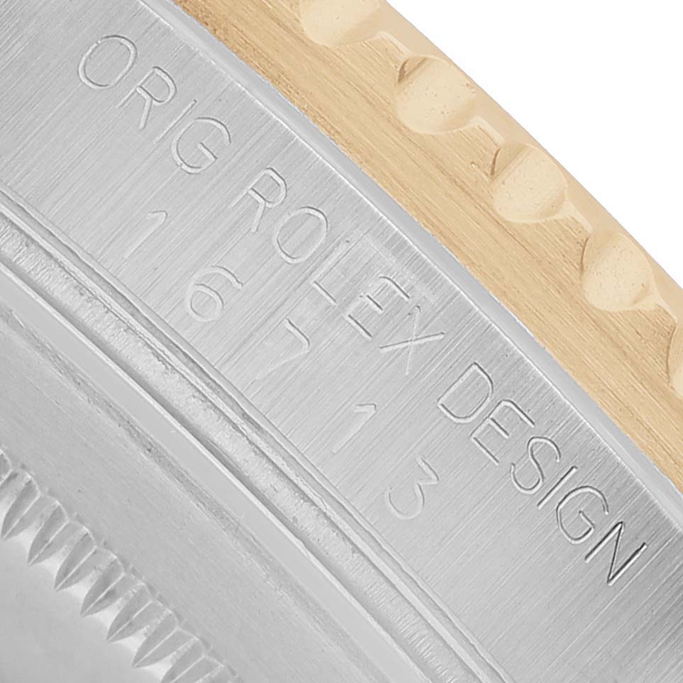 The image shows a close-up of the engraved side of the case back of a Rolex GMT-Master 16713 Men's Steel and Gold (two tone) Black Dial, featuring the model number and brand name.