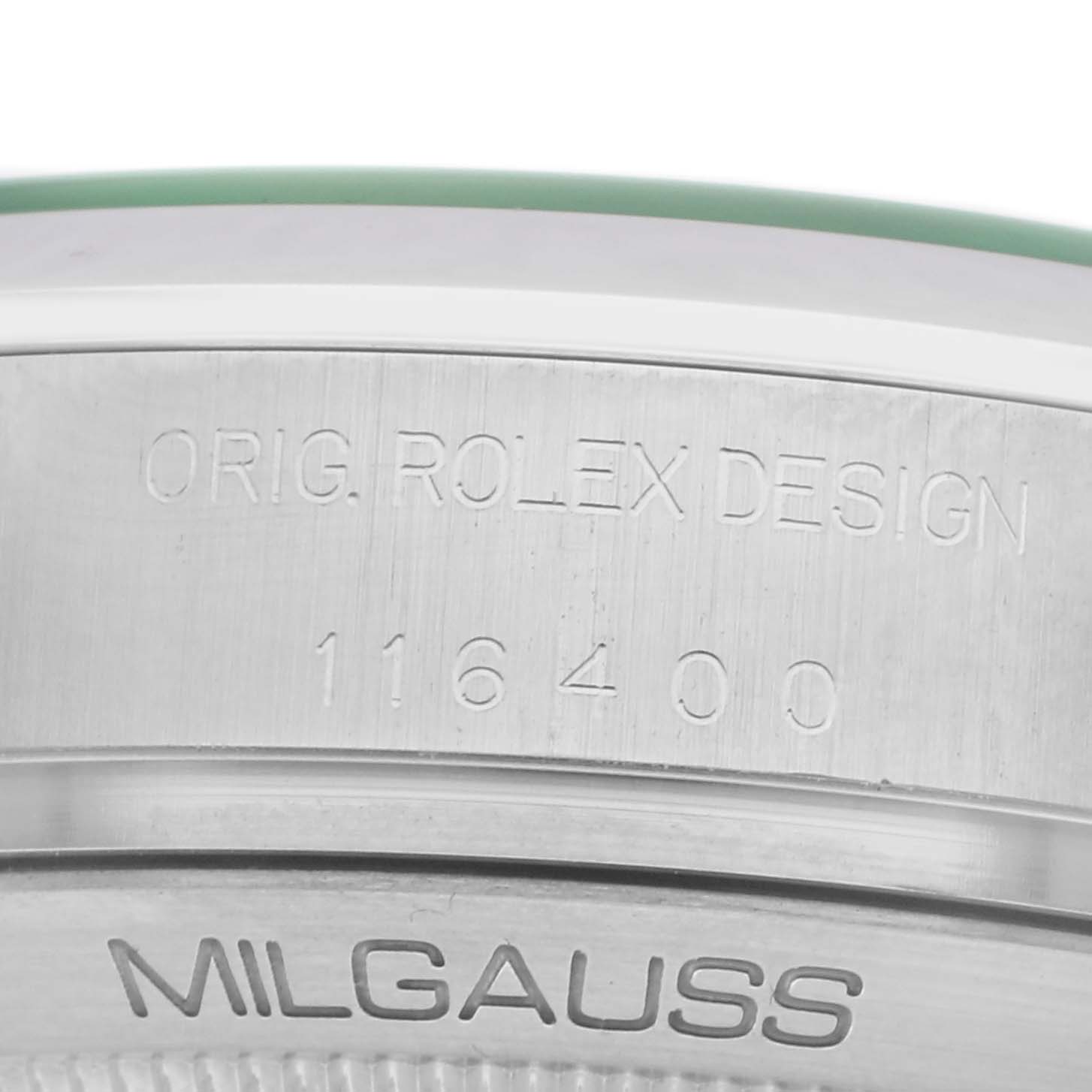 The image shows a close-up of the side of a Rolex Milgauss model 116400GV, featuring engraved text on the watch’s case side.