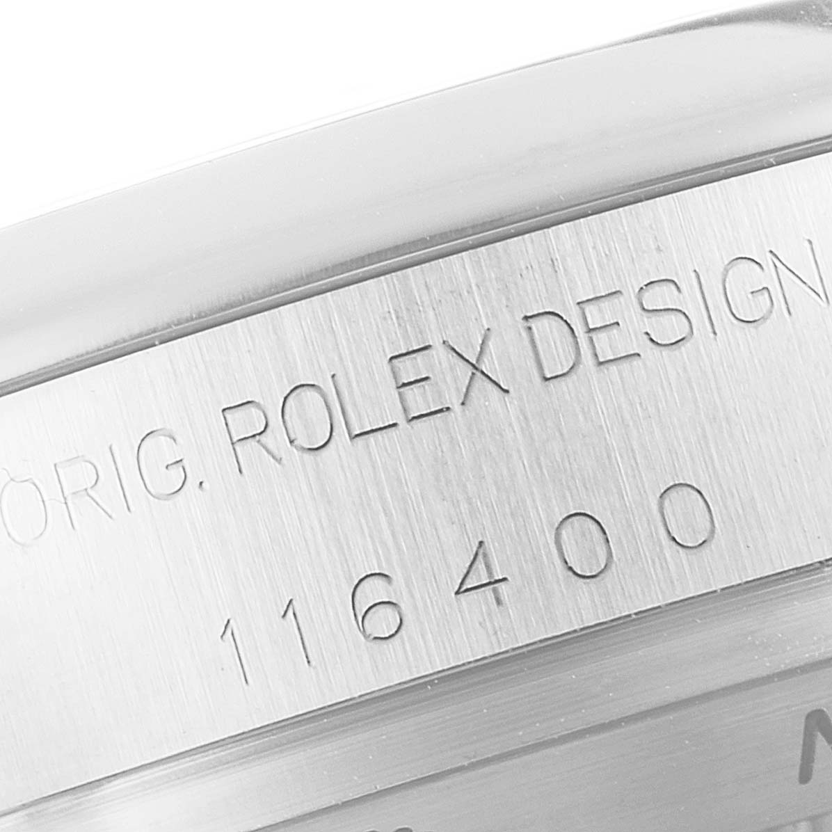 This image shows a close-up of the engraved text and serial number on the side of a Rolex Milgauss 116400 Men's Stainless Steel Black Dial 116400 Men's Stainless Steel Black Dial watch case.