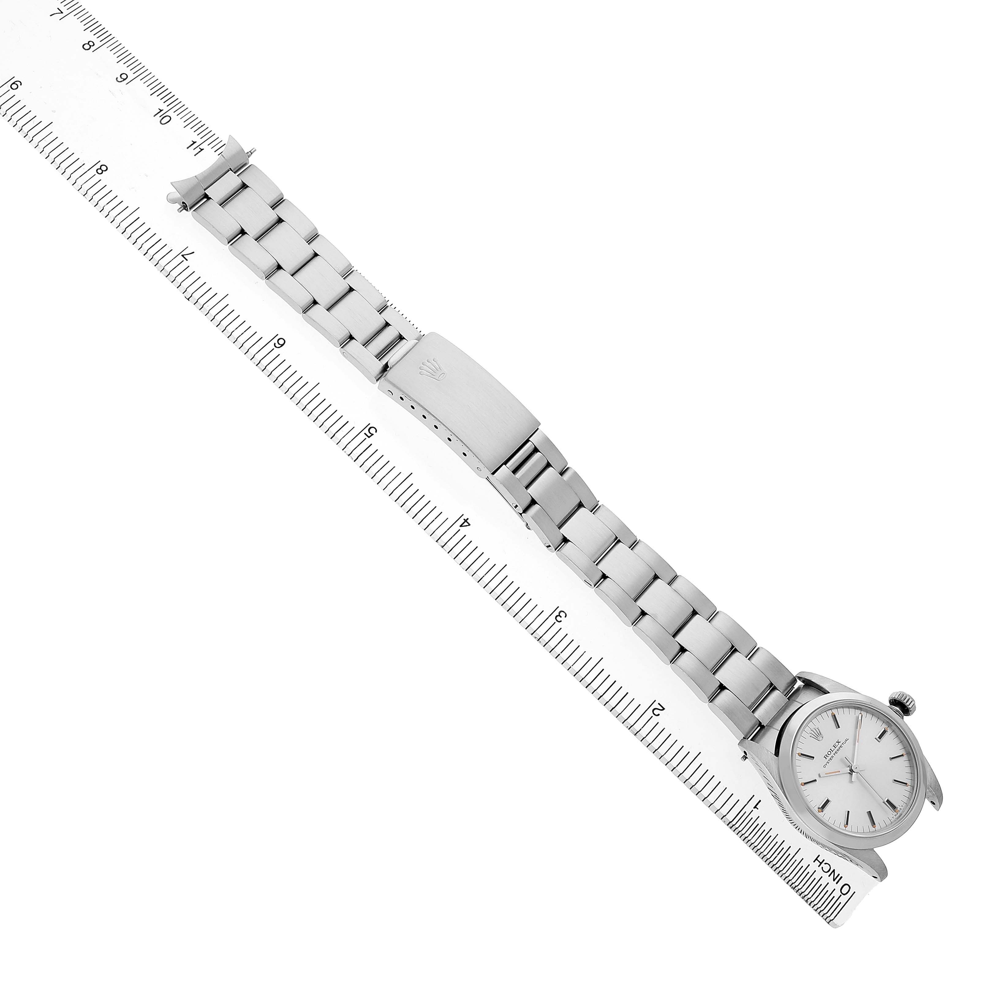 The Rolex Mid-Size 67480 Women's Stainless Steel Silver Dial watch is shown from a top view, displaying the dial, bracelet, and clasp.