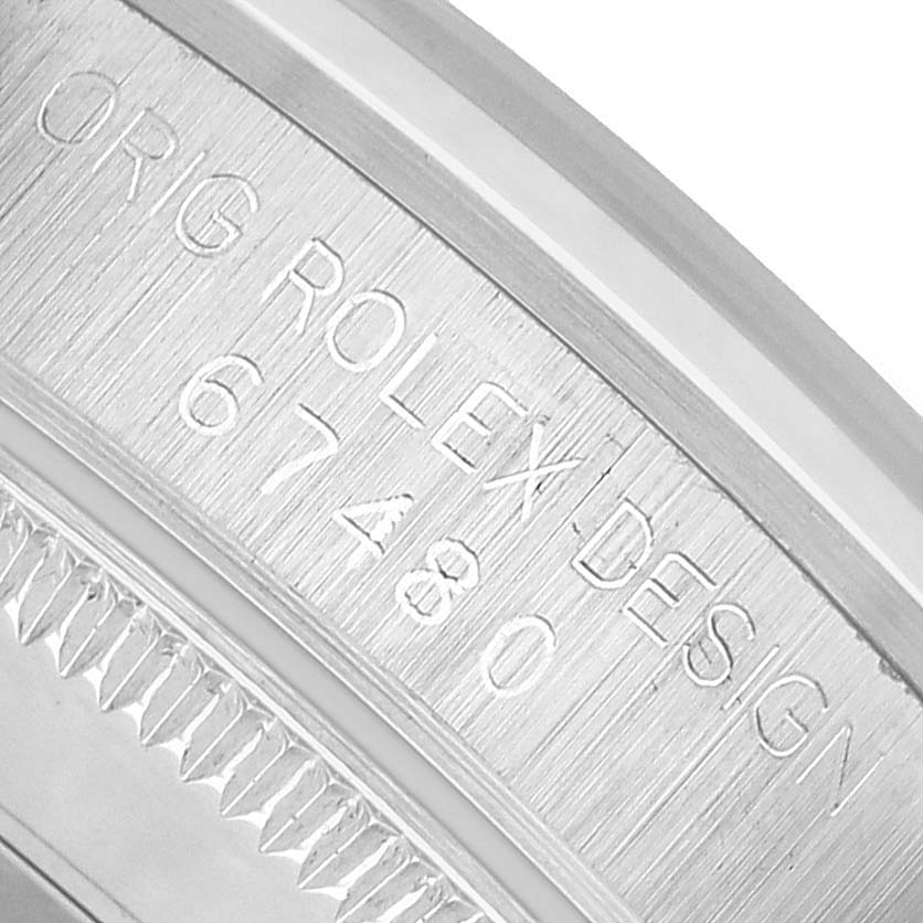 The image shows a close-up of the inner bezel with engravings on the Rolex Mid-Size 67480 Women's Stainless Steel Silver Dial watch.
