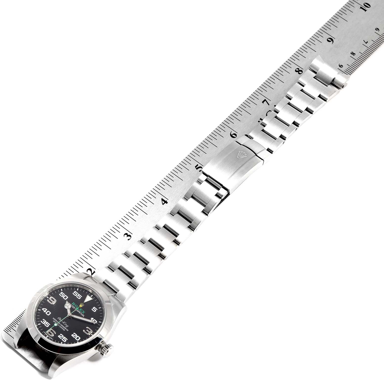 The image shows a Rolex Air-King 116900 Men's Stainless Steel Black Dial 116900 Men's Stainless Steel Black Dial watch laid flat with its bracelet extended next to a ruler.