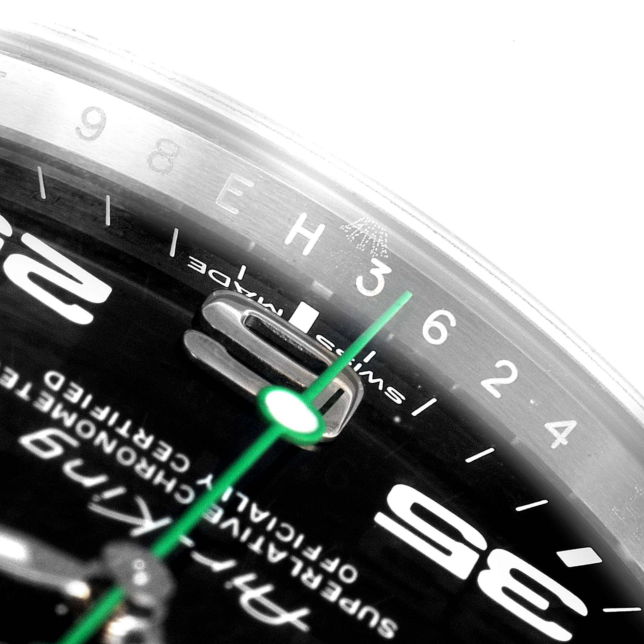 This close-up image of a Rolex Air-King 116900 Men's Stainless Steel Black Dial 116900 Men's Stainless Steel Black Dial watch face shows the hour marker numbers, green seconds hand, and branding text.