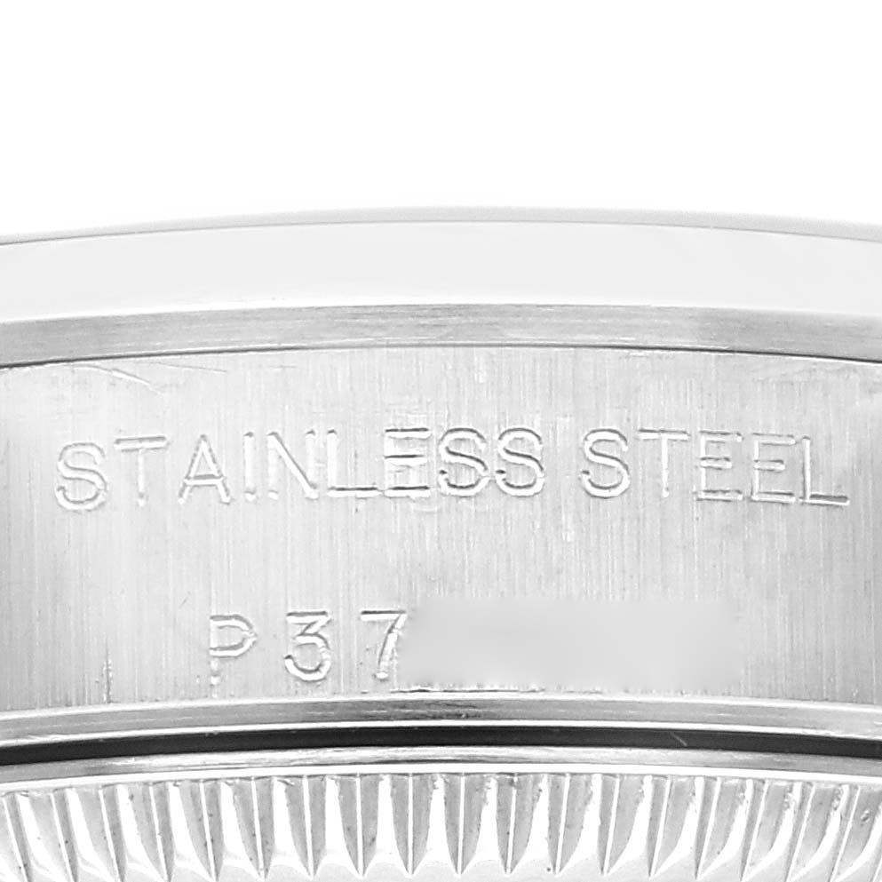 The image shows a close-up view of the stainless steel engraving on the casing of a Rolex Oyster Perpetual 76080 Women's Stainless Steel Blue Dial 76080 Women's Stainless Steel Blue Dial watch.