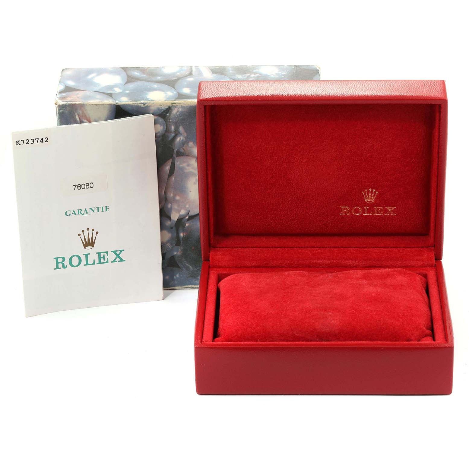 The image shows a red Rolex box and warranty card for the Oyster Perpetual model.