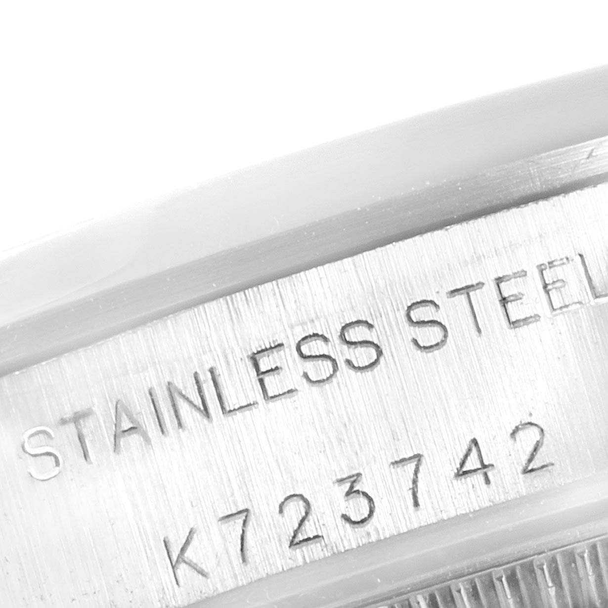 This image shows a close-up of the stainless steel caseback with the serial number of a Rolex Oyster Perpetual 76080 Women's Stainless Steel Silver Dial 76080 Women's Stainless Steel Silver Dial watch.