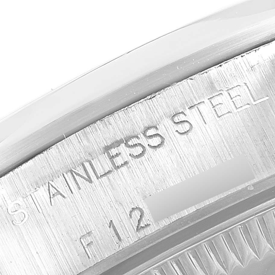 This image shows a close-up of the side of a Rolex Oyster Perpetual 76080 Women's Stainless Steel Pink Dial 76080 Women's Stainless Steel Pink Dial watch, specifically highlighting the "STAINLESS STEEL" engraving.