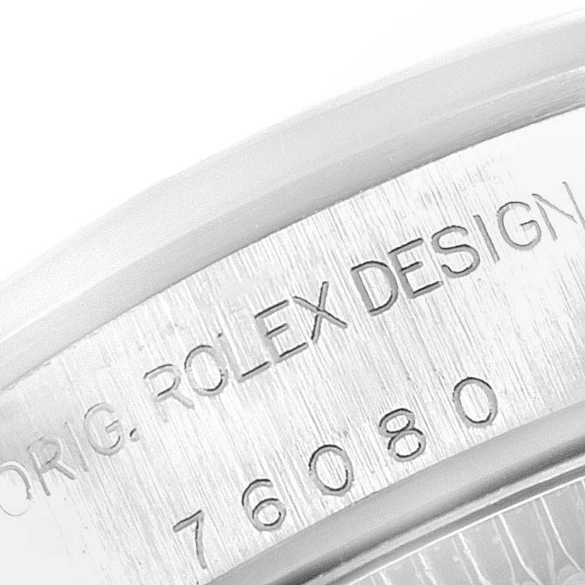 This image shows a close-up of the case back engraving on a Rolex Oyster Perpetual 76080 Women's Stainless Steel Pink Dial 76080 Women's Stainless Steel Pink Dial watch, highlighting part of the serial number.