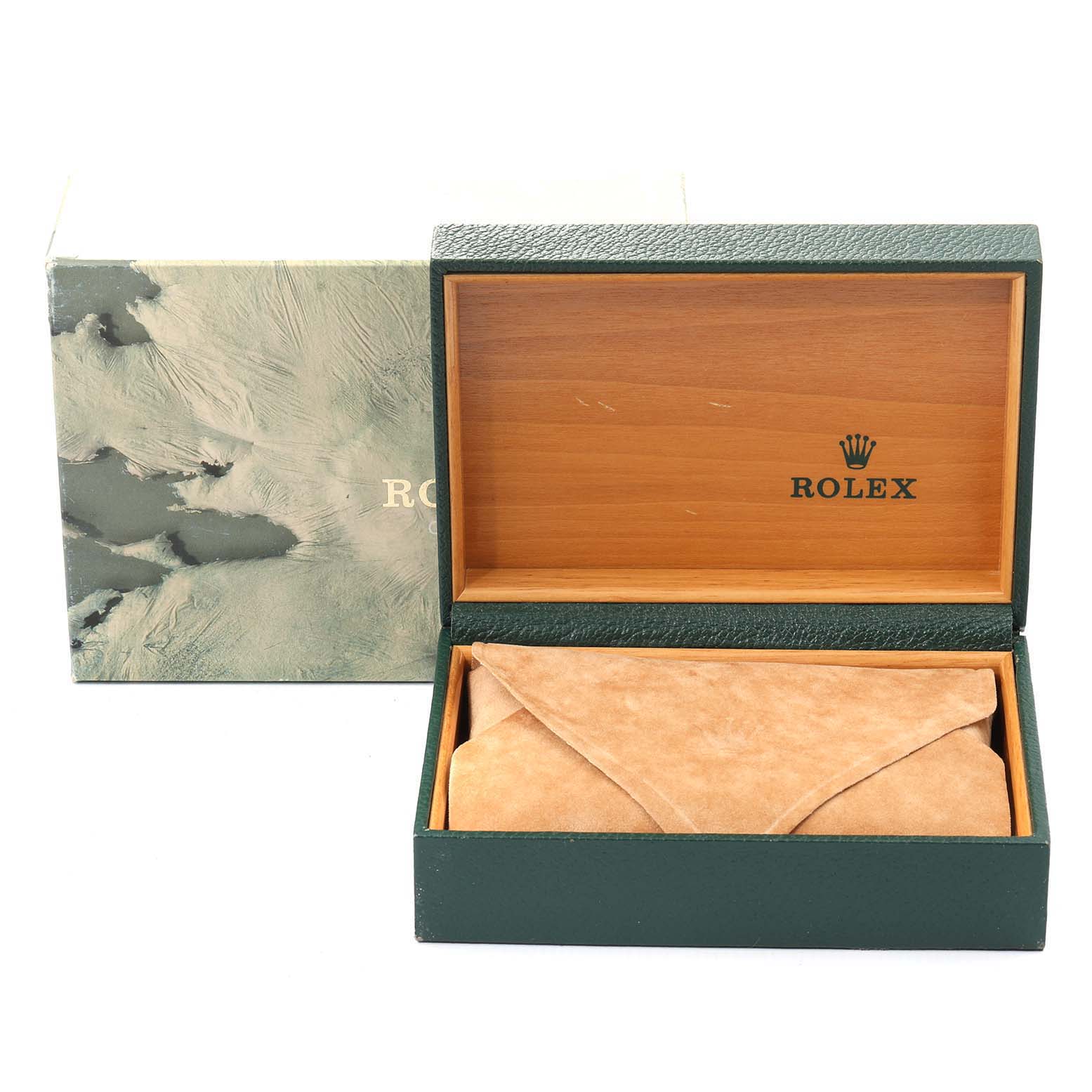 This image shows an open Rolex box containing a suede pouch, part of the Vintage Collection model by Rolex.