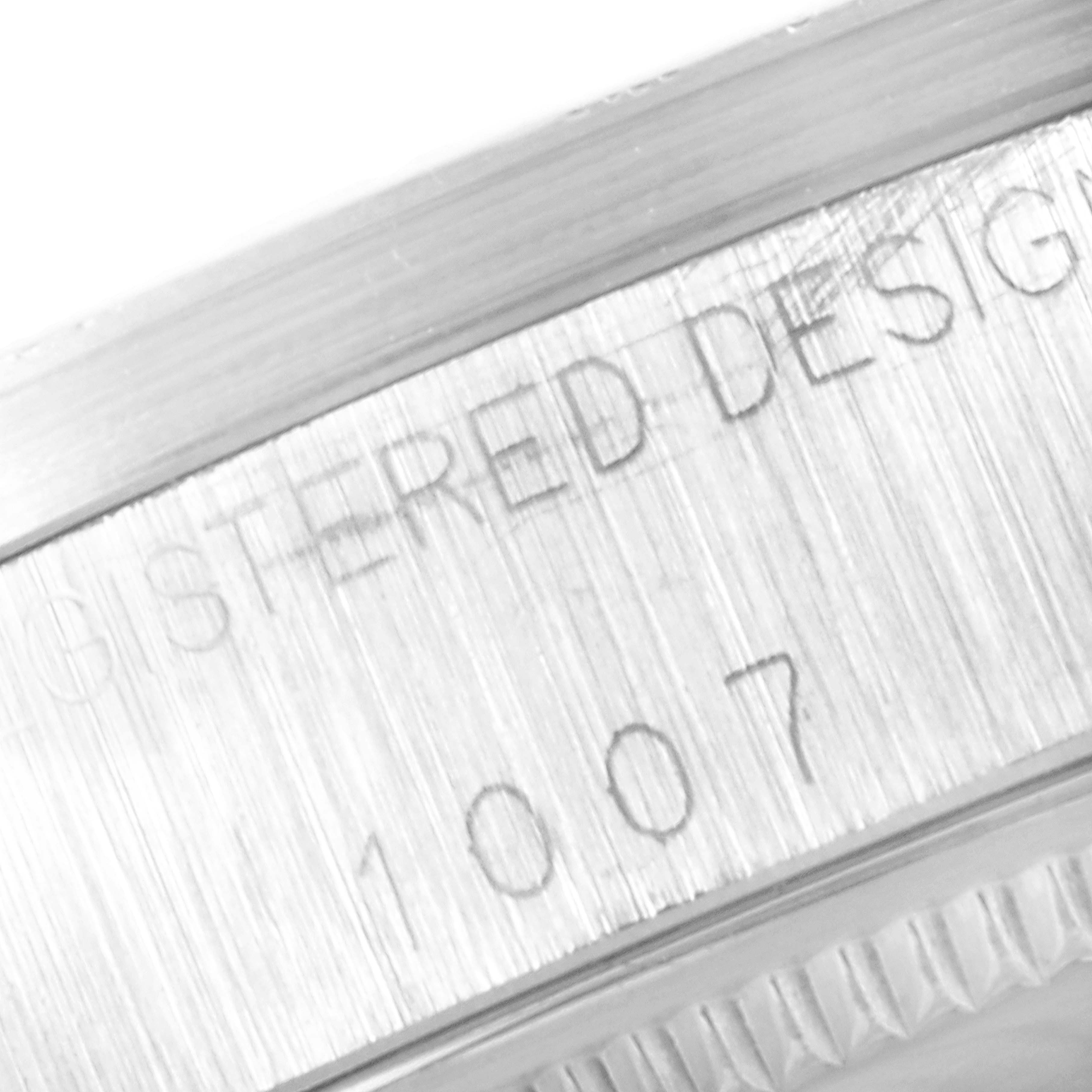 The image shows a close-up of the engraved bezel and part of the case back from a Vintage Collection model by Rolex.