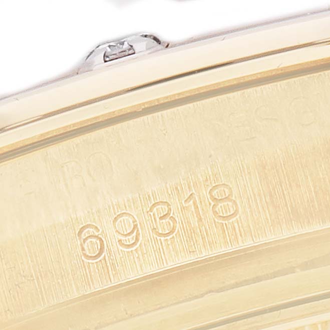 This close-up image shows part of the gold case back of a Rolex Pearlmaster, model number 69318, focusing on the engraved number detail.