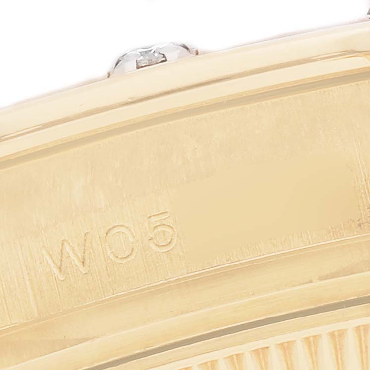 The image shows a close-up of the side and bezel of a Rolex Pearlmaster model 69318, highlighting part of the gold case with a visible engraving.
