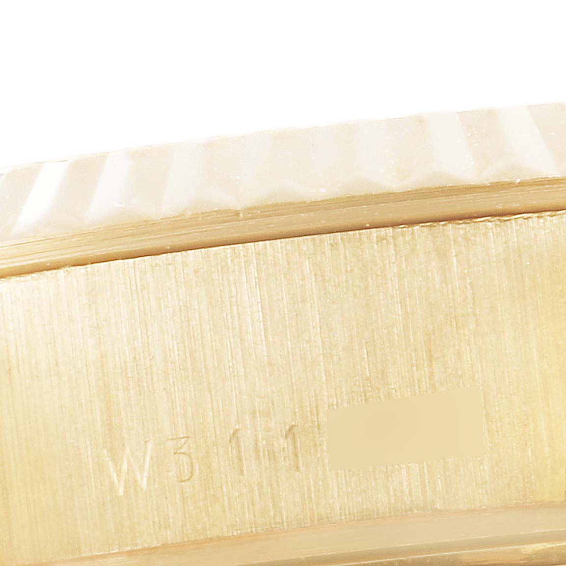 This close-up shot of the Rolex President 69178 Women's Yellow Gold Champagne Dial 69178 Women's Yellow Gold Champagne Dial model shows the watch's gold case side engraved with serial numbers.