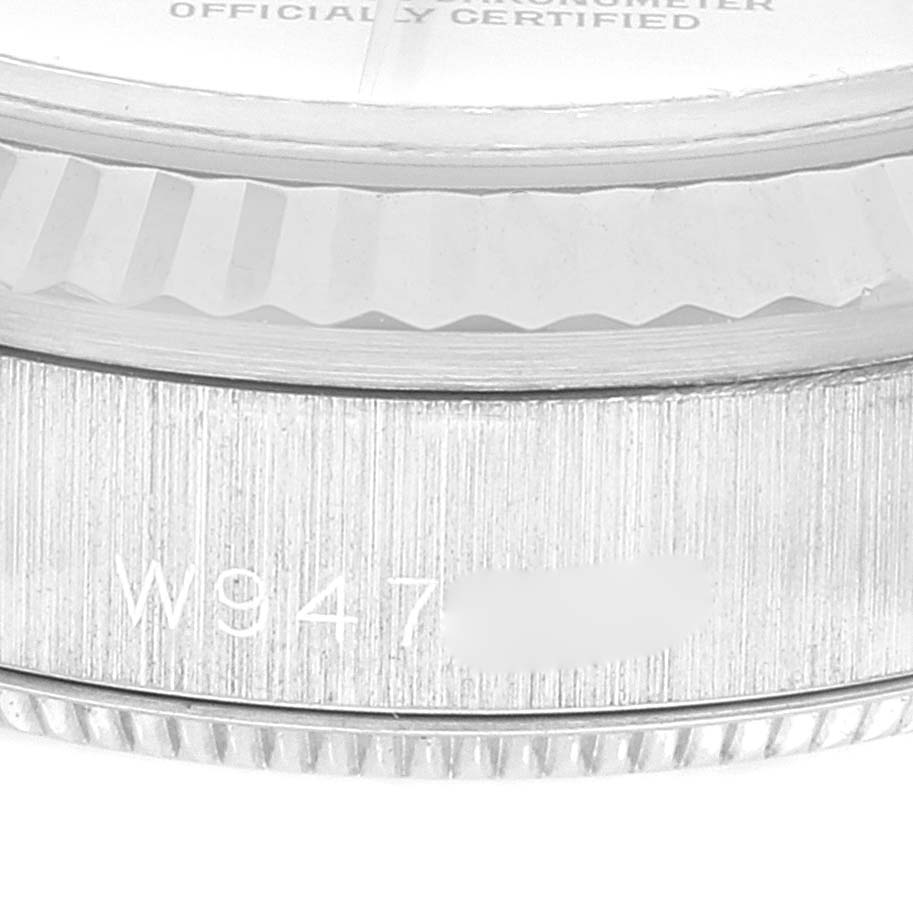 This close-up image shows the side of a Rolex President 68279 Women's White Gold Silver Dial 68279 Women's White Gold Silver Dial model watch featuring the case edge with an engraved serial number.