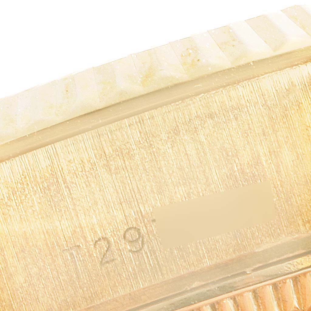 The image shows a close-up angle of the side of a Rolex President 69178 Women's Yellow Gold Champagne Dial 69178 Women's Yellow Gold Champagne Dial model watch, highlighting part of the bezel and serial number.