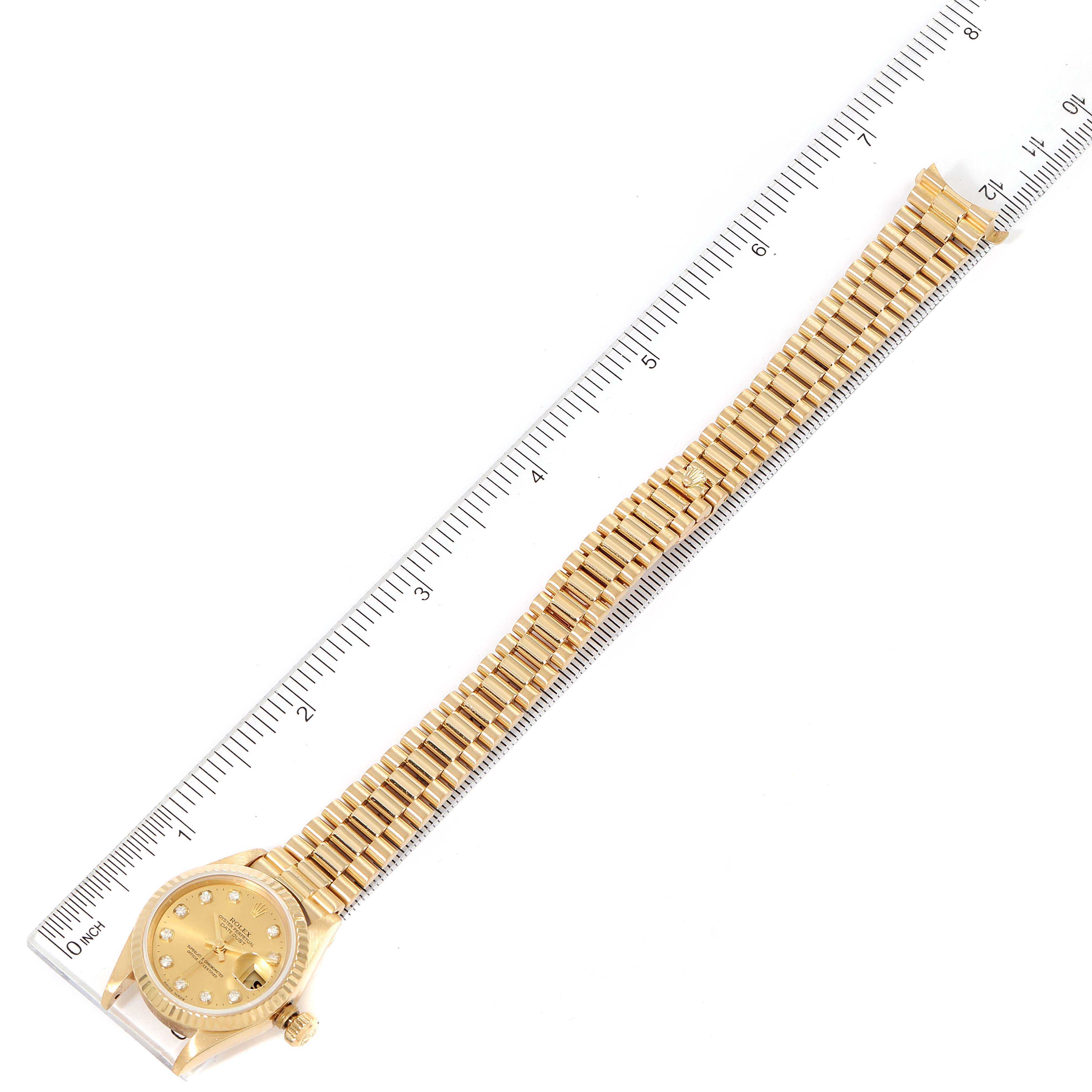 The image shows a Rolex President 69178 Women's Yellow Gold Champagne Dial 69178 Women's Yellow Gold Champagne Dial model watch laid flat next to a ruler, displaying the dial and full length of the bracelet.