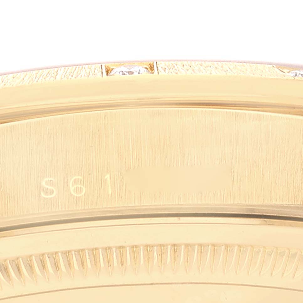 This image shows a close-up of the edge and engraving on the gold case of a Rolex President 18308 Men
s Yellow Gold Champagne Dial 18308 Men
s Yellow Gold Champagne Dial watch.