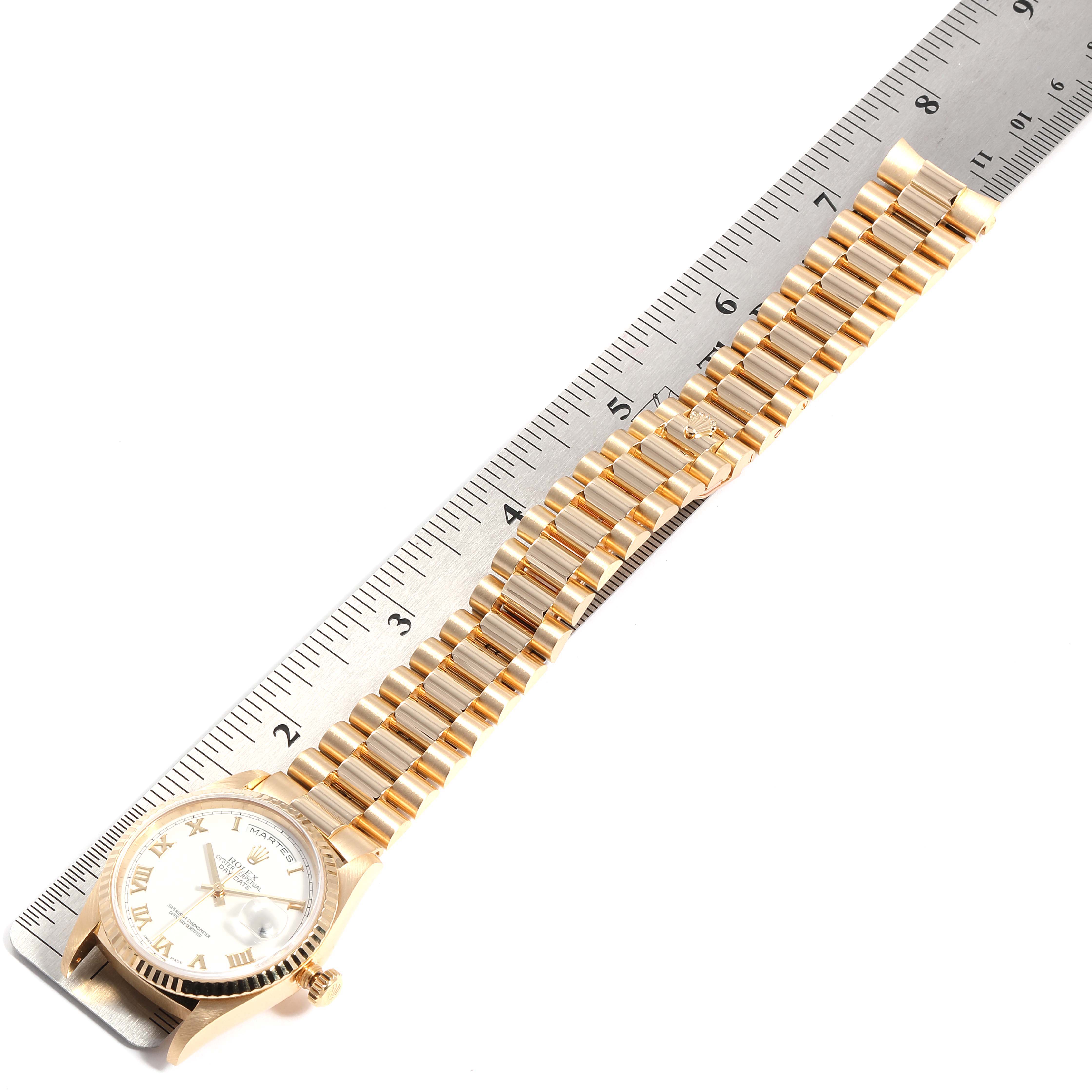 The image shows a gold Rolex President 18238 Men
s Yellow Gold White Dial 18238 Men
s Yellow Gold White Dial model watch horizontally next to a ruler.