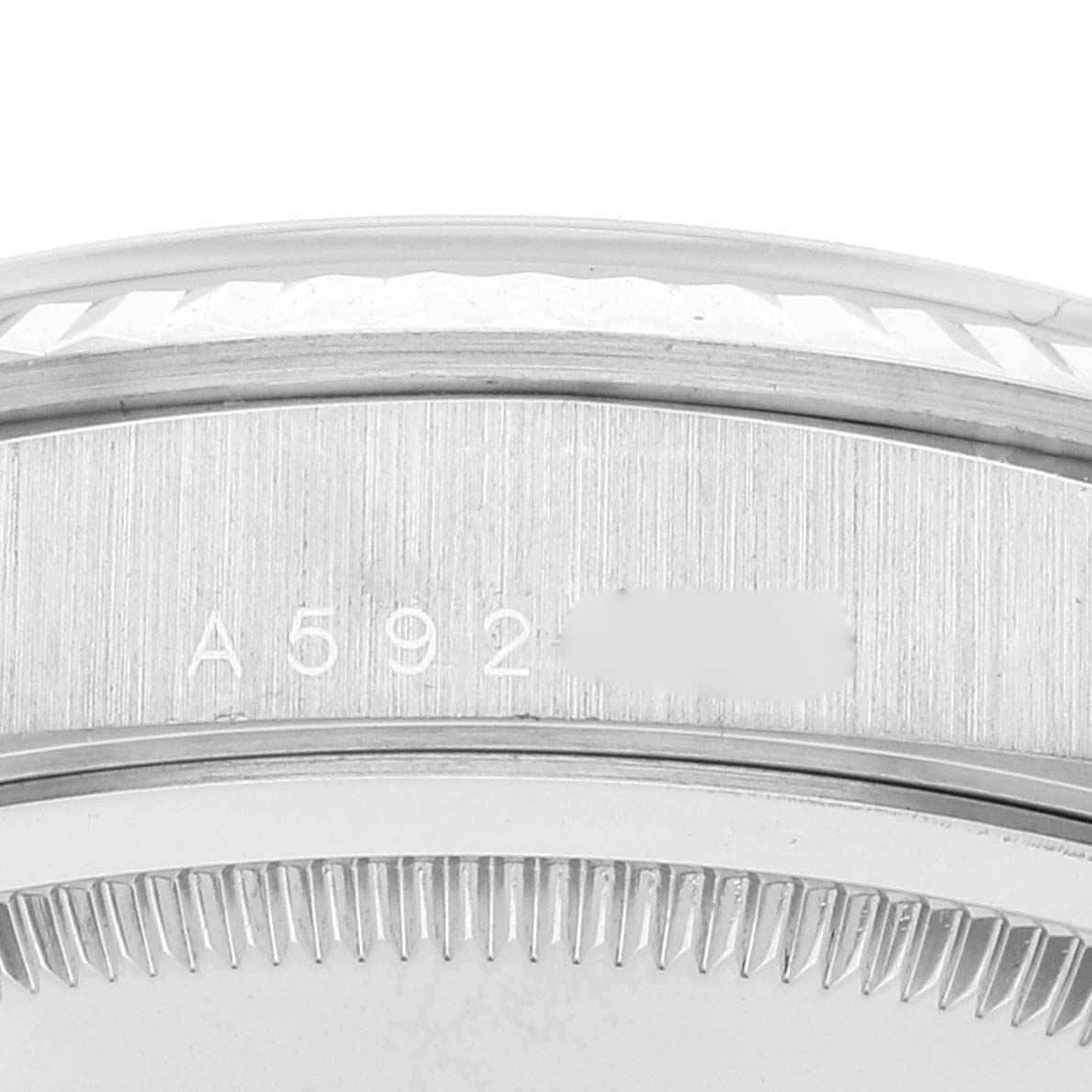 This close-up angle of a Rolex President 18239 Men's White Gold Silver Dial 18239 Men's White Gold Silver Dial model watch shows the case side with serial numbers engraved.